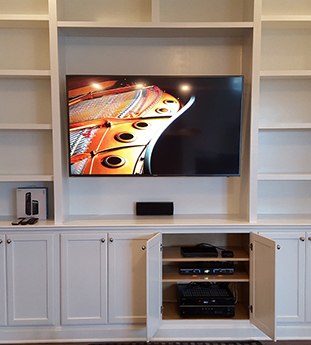 Wired Installations mounted TV in custom cavity, concealed wiring wall for HDMI to TV and speaker wire for in-ceiling speakers with center speaker below TV, connected receiver, programmed RF universal remote<br>

Brands: Samsung, Yamaha, Logitech Harmony, Sanus, Episode
